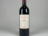 the bottle of red wine is sitting on the table