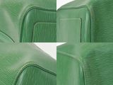 two pieces of green leather on a white surface