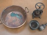 a metal pan with a handle and some other items on a table