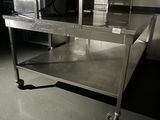 a stainless steel table with a microwave on top of it