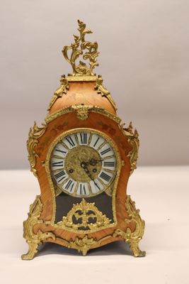 a clock that is sitting on a white table