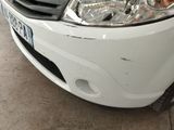 a picture of a car that has been dented and is parked in a garage