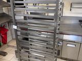 a metal rack that has a bunch of trays on it