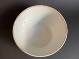 a white bowl sitting on a table with a sticker on it