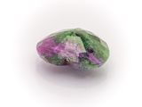 a close up of a green and purple stone on a white surface