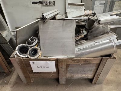 a pile of metal items in a box on the floor