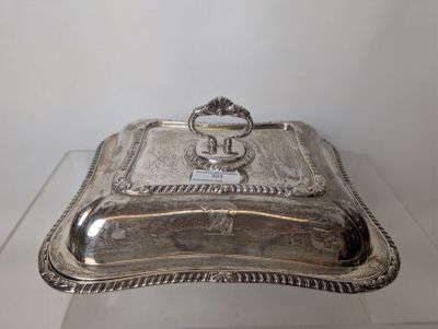 a silver plate with a handle on top of it