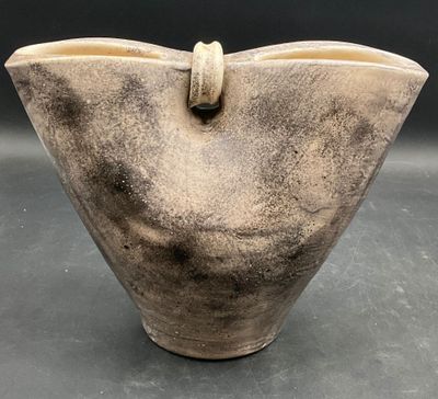 a large brown vase with a handle on it