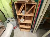 a wooden shelf in the corner of a room