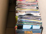 a cardboard box full of dvds in it