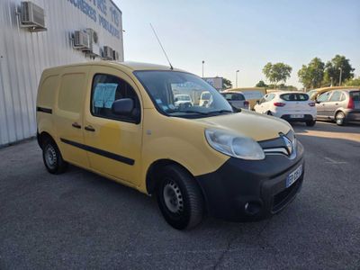 the small yellow van is parked in the parking lot