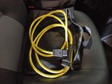 a yellow cable connected to a black bag in the back seat of a car