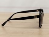 sunglasses on a table with a white wall in the background