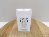 a white box sitting on top of a wooden table next to a white wall