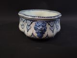 a blue and white bowl with a lion on it