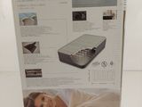 packaging of a box containing a mattress and a box with a picture of a woman laying on it