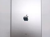 an apple ipad sitting on top of a white table next to a white wall