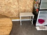 a small table and a small refrigerator in a room