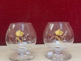 two wine glasses sitting next to each other on a table