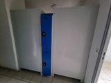 a bathroom with a blue door and a tiled floor
