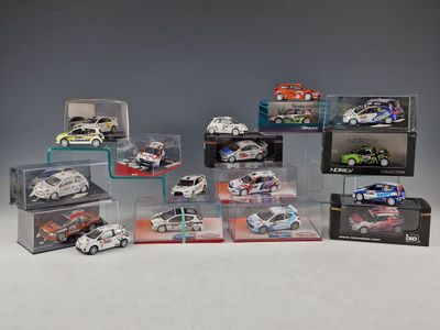 a group of toy cars in display cases sitting on a table
