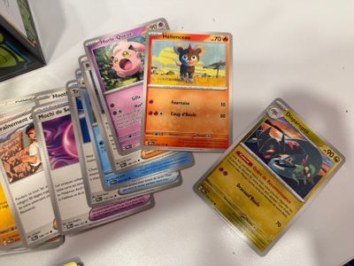 a lot of pokemon cards on the table