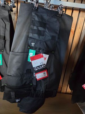 two pairs of pants hanging on a rack in a store