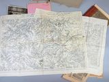 a map on a table next to a bunch of old books