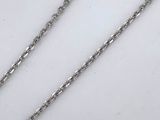 two silver chains on a white surface with a white background