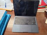 a laptop computer sitting on top of a wooden desk