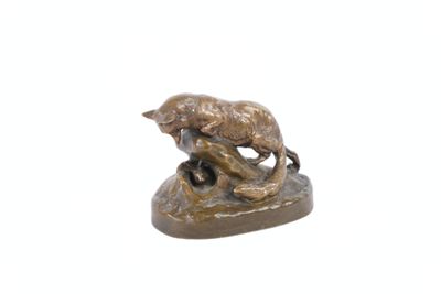 a bronze statue of a bear and a dog on a rock