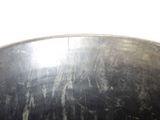 a close up of a black bowl with a white background