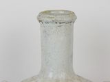 a white vase that is sitting on a table