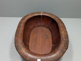 a wooden bowl that is sitting on a table