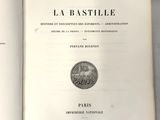 un livre ouvert posé sur une table, à côté d'une pièce de monnaie