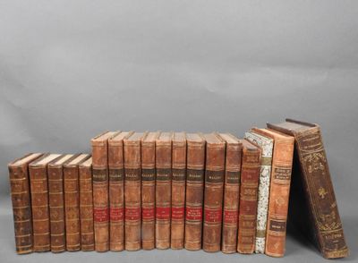 several old books stacked on top of each other on a gray surface