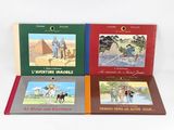 three books on a white surface with a picture of a man riding a horse