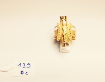 a gold ring that has a picture of a man on it