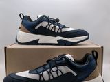 a pair of blue and white sneakers sitting on top of a box