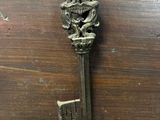 a metal key on a wooden box with a keyhole