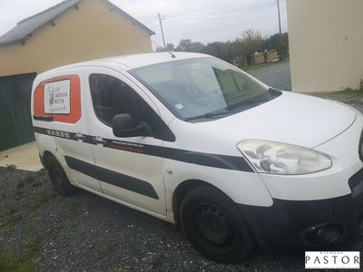 a small white van parked in front of a building