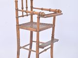 a wooden chair with a woven seat on a white background