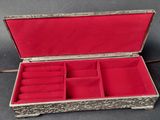 a silver and red box with several rings inside of it