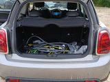the back of a car with its trunk open and a bunch of wires in the trunk