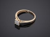 a yellow gold engagement ring with a single diamond