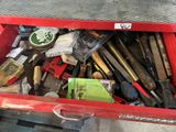 a red tool box full of tools on the floor