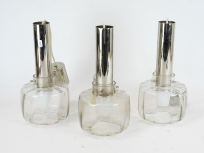 three clear glass bottles with silver tops and a silver stopper