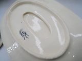 a close up of a white plate with a blue design on it