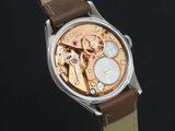 a close up of a watch with a brown strap