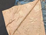 two pieces of blue and gold silk with floral designs on them